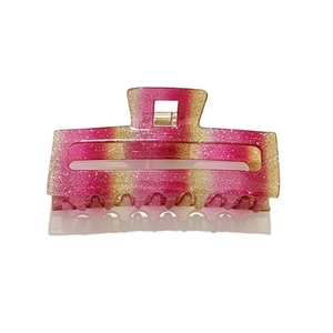 Macro detail of rainbow glitter hair claw clip with gradient pink to gold finish and metal spring