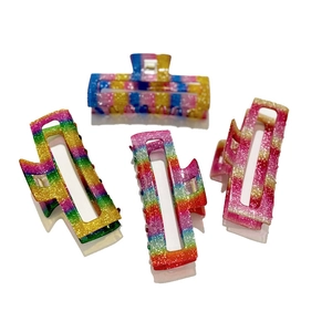 Set of 4 rainbow gradient hair claws with glitter finish in rectangular hollow design
