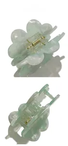 Detailed top and side views of the mint green floral hair claw clip with marble texture