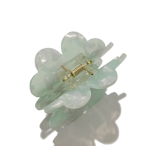 Mint green clover acetate claw clip with marble texture and golden metal spring