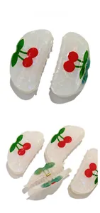 Detail view showing cherry pattern on white semi-transparent hair claw clips from multiple angles