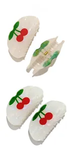 Detail display of semi-circle cherry hair claw clip made of white acetate and gold metal