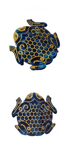 Macro shot of deep blue acetate fish hair claw with intricate gold scale pattern details