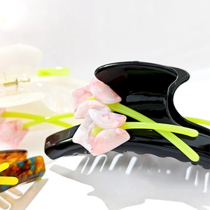 Elegant black acetate hair claw clip featuring pink marble tulip flower design