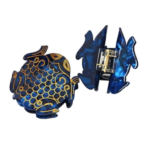Pair of large blue acetate fish hair claws with gold marble texture for women hair styling