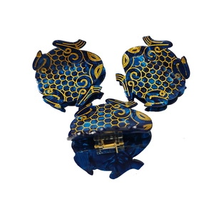 Golden-edged blue acetate fish-shaped hair claw clips with elegant wave pattern