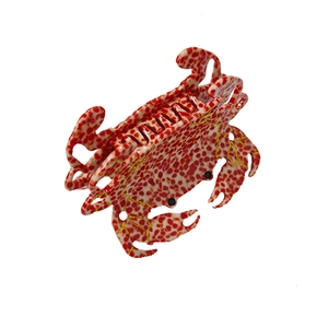 French crab-shaped hair claw clip in red and white polka dot acetate with gold patterns