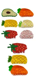 Detailed close-up of colorful fruit-themed acrylic hair claws in multiple shapes