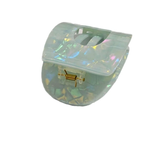 Flat circular iridescent light green acetate hair claw clip with golden metal spring