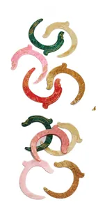 Detail showing colorful marble texture acetate hair clips with golden dragon patterns