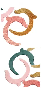 Macro view of marbled acetic acid dragon hair pins with intricate carved patterns