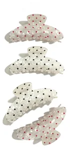 Vertical view of white marble acetate hair claws with classic red and black polka dots