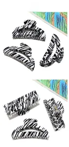 Detail view of large zebra pattern acetate hair claws in rectangular and arched shapes