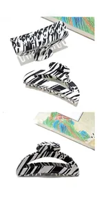 Macro view of large acetate shark hair claw clip with black and white zebra pattern