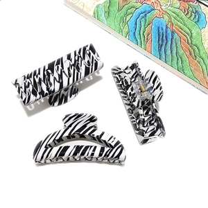 Three-piece black and white zebra pattern acetate hair claws in various shapes on white back