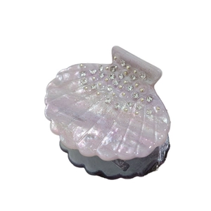 Sparkly purple shell-shaped hair claw clip with rhinestones and iridescent glitter finish