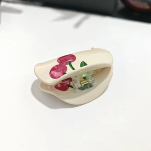 French style creamy white cherry hair claw clip with glossy finish for elegant updo styles