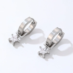 Detailed macro view of silver hoop earring featuring a cubic zirconia star charm
