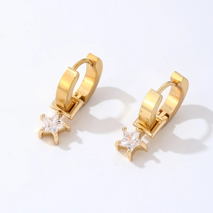 Detail of gold-plated huggie earrings featuring star-shaped clear cubic zirconia pendants