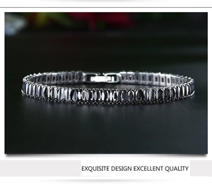 Detailed macro view of black rectangular zircon stones set in a silver-tone tennis bracelet