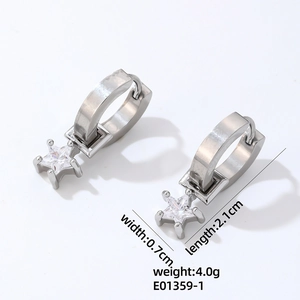 Detailed macro view of silver hoop earrings with sparkling star-shaped zircon pendants