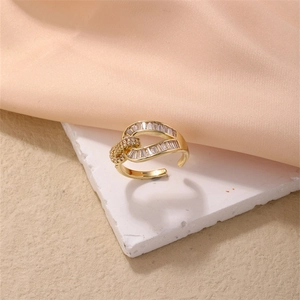 Detailed macro of gold-plated knot ring with clear cubic zirconia stones and open band