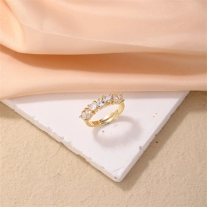 Detailed view of adjustable gold ring with five heart-shaped cubic zirconia on stone base