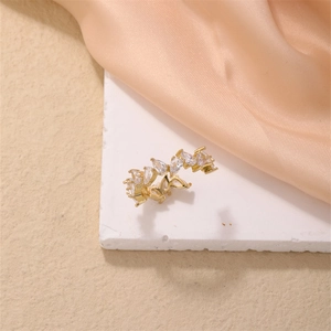 Close-up of golden adjustable ring with marquise-cut zircons on a white stone base