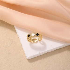 Macro view of adjustable gold ring with three clover motifs and pave-set zircons