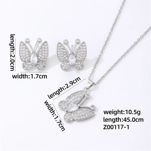 Macro detail of silver butterfly necklace and earrings set with micro-paved cubic zirconia