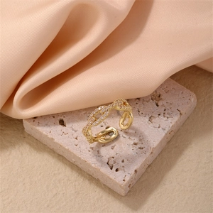 Elegant adjustable gold chain ring with pink zirconia on a soft pink silk background