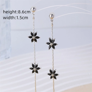 Detail of silver tassel earrings with black flower zircon, height 8.6cm and width 1.5cm