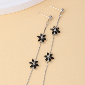 Elegant long silver tassel earrings with black zircon flower charms and sparkling stones