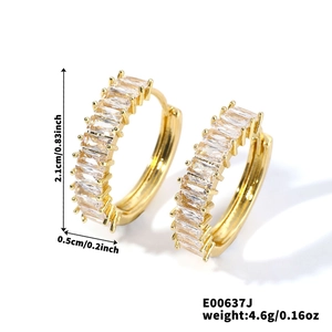 Detail view of gold hoop earrings with baguette-cut crystals and product measurements