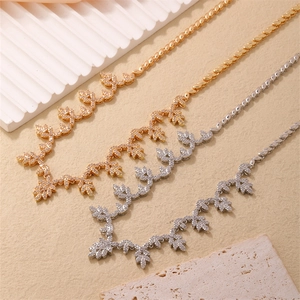 Minimalist gold and silver flower leaf necklaces set with sparkling crystals