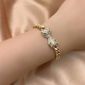 Close-up of golden Cuban chain bracelet with double fox heads and sparkling zircon detail