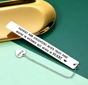 Macro view of stainless steel bookmark with dad heart pendant and engraved daughter's quote