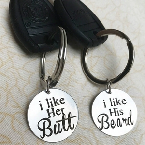 Close-up of stainless steel keychains with creative funny engraving for couples