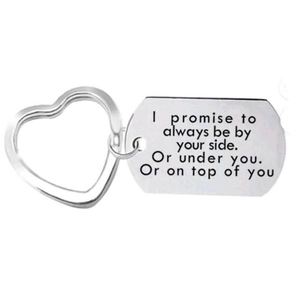 Close-up of engraved stainless steel heart keychain with humorous romantic message