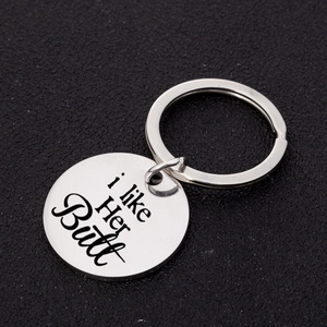 Polished stainless steel round keychain with engraved 'I like her butt' text