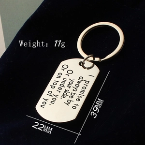 Polished stainless steel keychain with engraved rectangular tag on blue velvet background