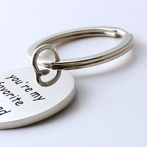 Close-up of heart-shaped stainless steel keychain with you are my favorite dad engraving