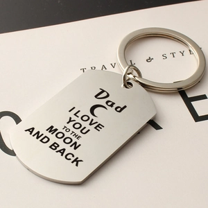 Close-up of stainless steel dog tag keychain with Dad I love you to the moon engraving