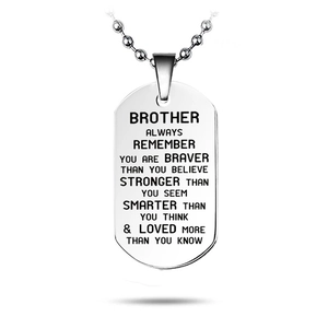 Macro shot of silver stainless steel dog tag pendant with laser engraved brotherly quote