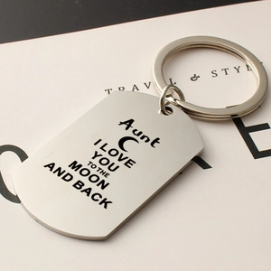 Macro shot of stainless steel rectangular keychain with engraved heart and moon quote