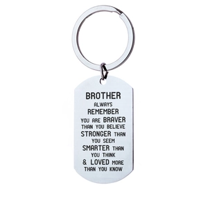 Macro detail of silver stainless steel dog tag keychain with engraved brother quote