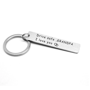 Detail showing brushed stainless steel keychain with Drive Safe Grandpa engraved message