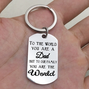 Macro detail of rectangle stainless steel keychain with engraved quote for Father's Day