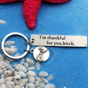 Stainless steel keychain with I'm thankful for you text and pinky swear charm over sea sand