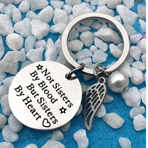 Stainless steel friendship keychain with Not Sisters By Blood engraved disk and pearl charm